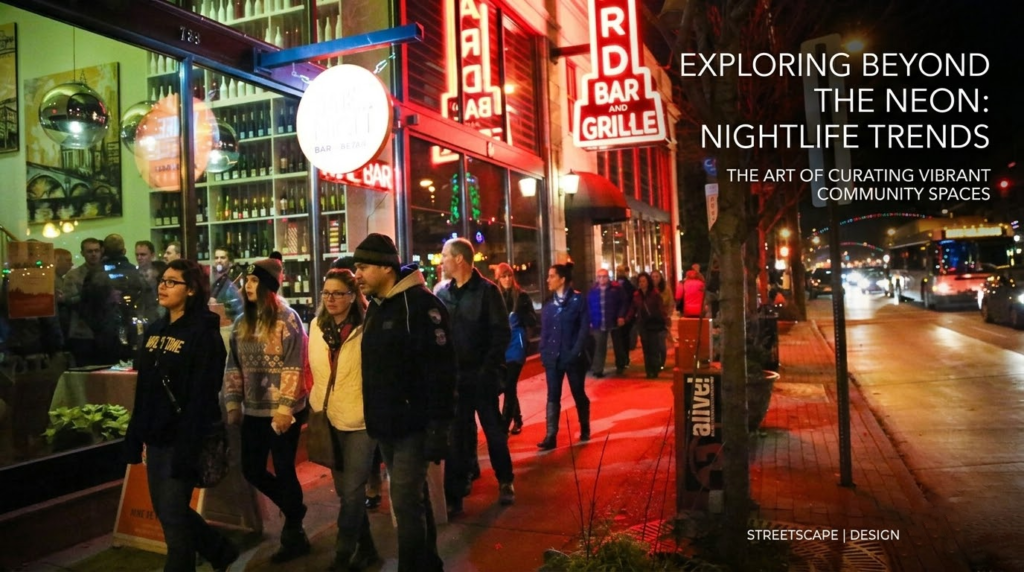 Vibrant night scene of people walking past neon-lit storefronts in the Short North Arts District.